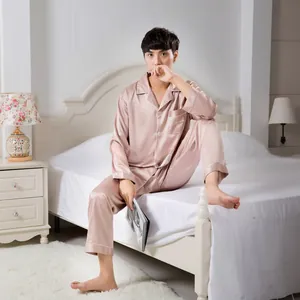 Detail of men's satin pajama set featuring silk-like fabric and white piping detail