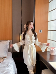 Detailed view of cream satin loungewear with golden lace trim and flared sleeve cuffs