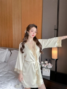 Detail of champagne satin robe with intricate lace trim and matching silk waist tie