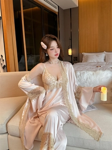 Detailed view of luxury silk pajama set with lace trim and elegant champagne satin texture