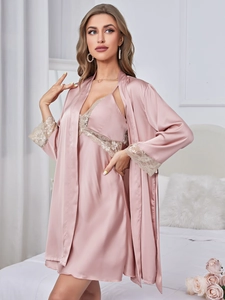 Detail view of pink satin pajama set with floral white lace trim on the robe and nightdress