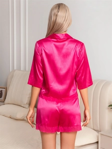 Rear view of pink silk pajamas set featuring delicate lace trim on hem and shorts