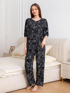 Detail of floral print women's cotton sleepwear set with short sleeves and long pants