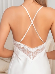 Detail of white satin nightgown with cross straps and floral lace back design