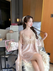Detailed view of pink satin robe with delicate lace sleeves and silk bow accents