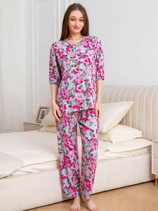 Close-up of pink floral patterns on lightweight light blue pajama set with buttons