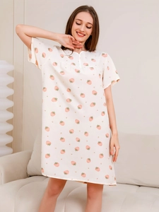 Close-up of soft cotton nightgown with pink strawberry print and buttoned neckline