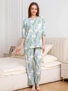 Detail of light blue floral pajama set with yellow tulip patterns and button-up front