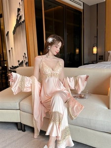 Lace trim detail on pink satin camisole set with floral embroidery and silky texture