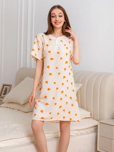 Detail of cream V-neck cotton nightgown featuring vibrant orange fruit prints