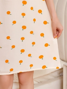 Macro detail of breathable seersucker fabric with orange print for summer nightgown