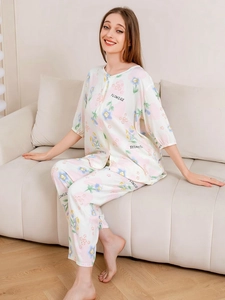 Close-up of floral and heart print detail on lightweight women's pajamas set in beige