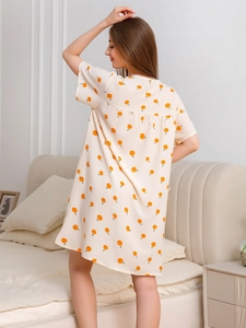 Detail of soft bubble cotton nightgown featuring vibrant orange prints and loose stitching