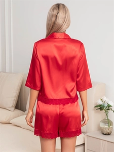Rear view of red satin pajamas set with short sleeves and delicate lace edge detailing