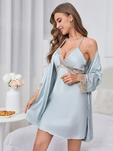 Detail of light blue satin pajama set showing exquisite beige lace on sleeves and neckline
