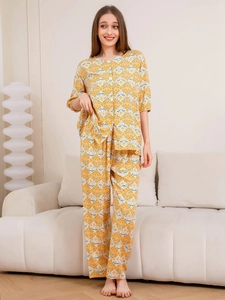 Detail of floral printed women's cotton sleepwear set in mustard yellow color