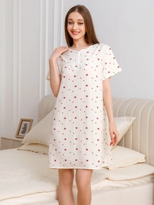 Close-up detail of soft cotton nightdress with cute red heart print and V-neckline