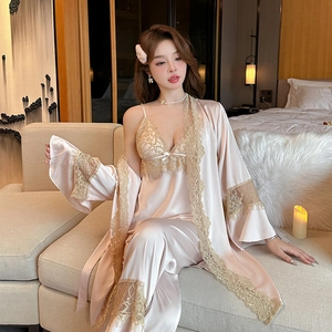 Three-piece pink satin pajama set with lace trim featuring a robe, camisole, and pants