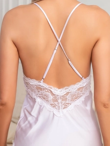 Detailed back view of white silk pajama with cross straps and delicate lace trim
