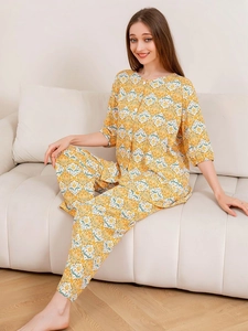 Detail view of cotton pajama set with vintage floral tile patterns and button front top