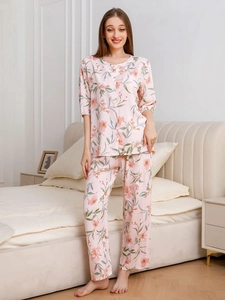 Detail of floral print rayon pajamas set with button-up sleeves and long pants for women