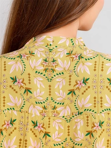 Close-up of yellow floral pajamas featuring intricate back print and mandarin collar