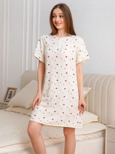 Detail of short sleeve women's nightgown with red heart prints on soft cotton fabric