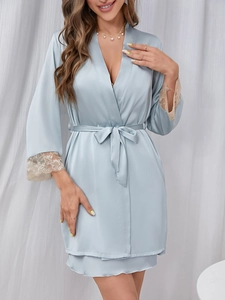 Detail of light blue satin robe with delicate lace trim on sleeves and V-neckline