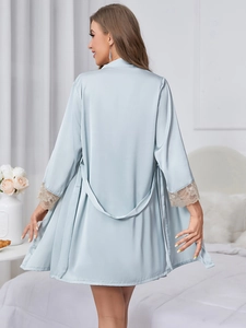 Back view of light blue satin bathrobe with delicate lace cuffs and waist tie in bedroom