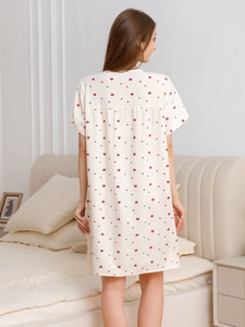 Detail of soft seersucker fabric with red heart print on summer women nightgown