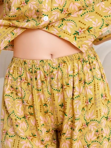 Close-up of ginger floral pajama set featuring detailed buttons and elastic waistband