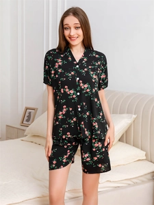Close-up of black V-neck pajamas set with red floral prints and front buttons