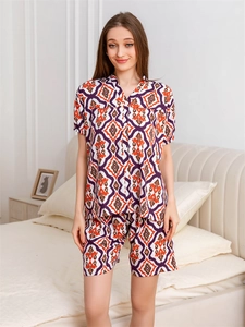 Detail of women's pajama set featuring ethnic geometric prints and button-down short sleeves