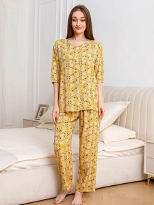 Close-up of yellow cotton floral pajamas featuring a short-sleeved top and loose trousers