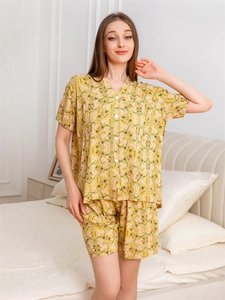 Close-up of rayon floral pajama set with yellow leaf print and white button details