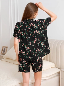 Rear view of black V-neck pajamas set with red floral print and loose shorts
