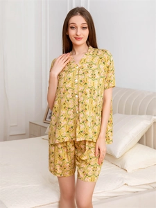 Close-up of yellow floral rayon pajamas set with pink leaf print and white buttons