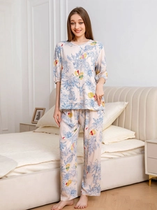 Detail of pink floral cotton pajamas set with blue flower patterns and button-up top