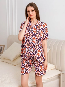 Detailed view of women's short sleeve pajamas with geometric patterns in bright orange and purple