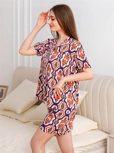 Detail of summer two-piece pajama set with orange geometric patterns and V-neckline