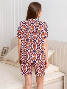 Back view of women's short-sleeve pajama set with ethnic geometric print on the bed