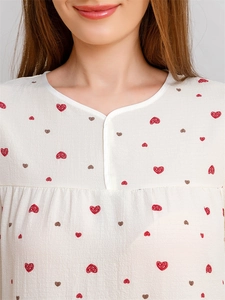 Detail of cute heart print on off-white short sleeve loungewear top with crew neckline