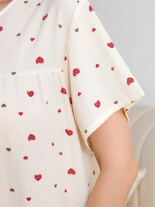 Detail of soft beige lounge top with cute hand-drawn red and brown heart pattern prints