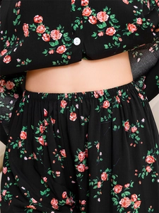 Detail view of elastic waistband and pink rose floral print on black rayon pajamas set