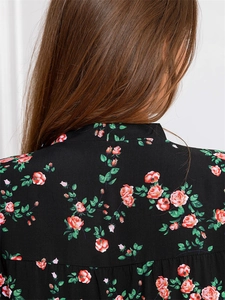 Close-up of V-neck back neckline on black rayon pajamas with red rose floral print