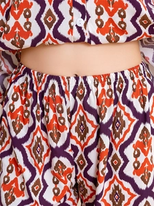 Detailed close-up of high-waist elastic band and vibrant Ikat geometric print on rayon pajamas