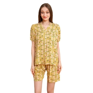 Women's yellow leaf print pajama set with short-sleeved shirt and elastic shorts