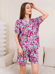Detail of light blue floral pajamas with short sleeves and a button-down V-neck collar