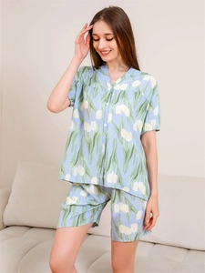 Detail of light blue pajama set featuring tulip floral prints and soft cotton texture