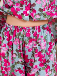 Detail of waist area showing floral leaf print fabric and elastic waistband on pajamas